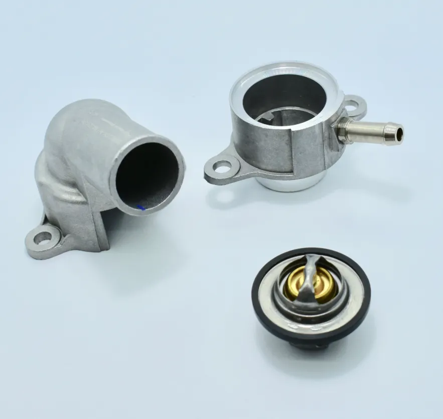 96282726-ALUM - Termostato Bomba de Agua para Chevrolet Aveo 08-18 1.6Lts, G3 06-10 1.6Lts en Bruck (87 Grados con Brida de Aluminio)